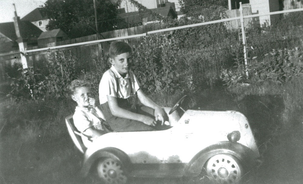 John Stubbs and a friend in a toy car