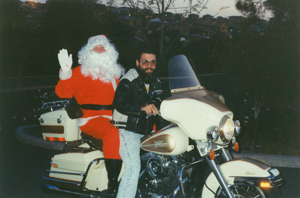 Santa arrives on a Harley Davidson at Carols by Candlelight