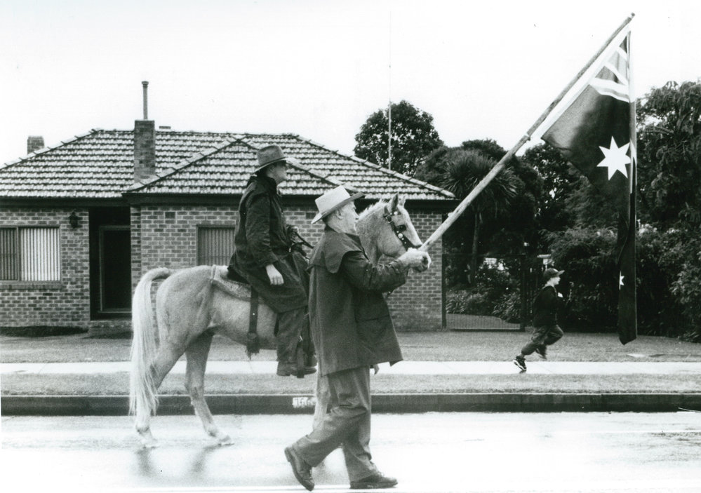 Brian Walsh with the Australian flag during Macquarie Pass Centenary Parade