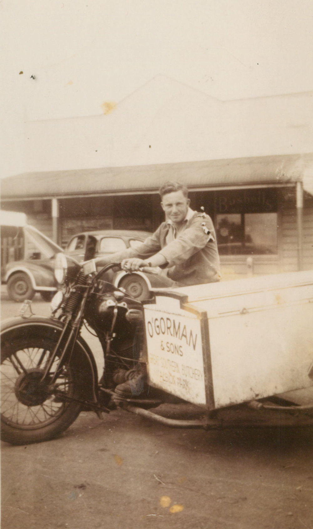Austin O'Gorman delivering meat on a 1939 Harley Davidson bike