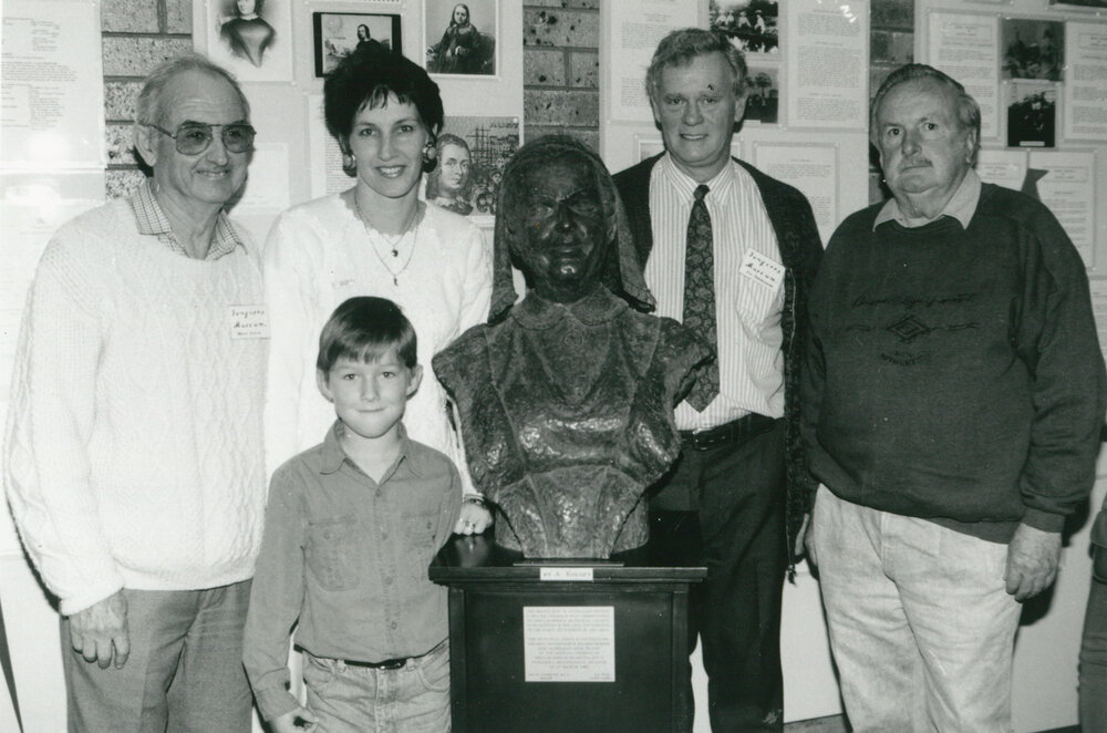Volunteers and visitors beside the Caroline Chisholm bust, part of the Tongarra Bicentennial Museum exhibition 'Year of the Family' in 1994