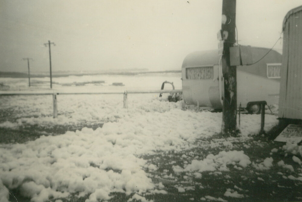Foam from rough seas flowing through Bassett Park Camp Ground, Shellharbour