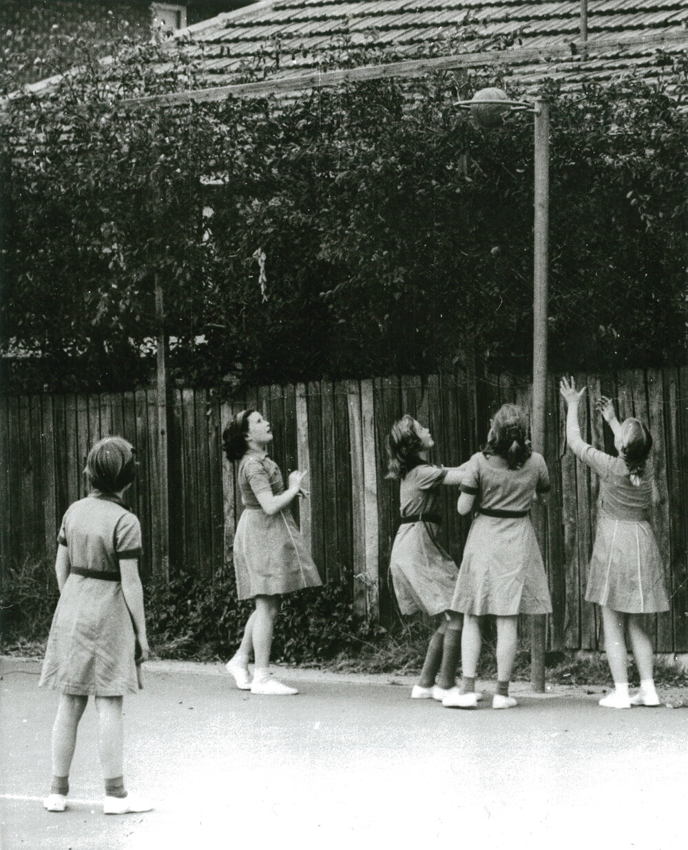Schoolgirls playing basketball in the 1950s