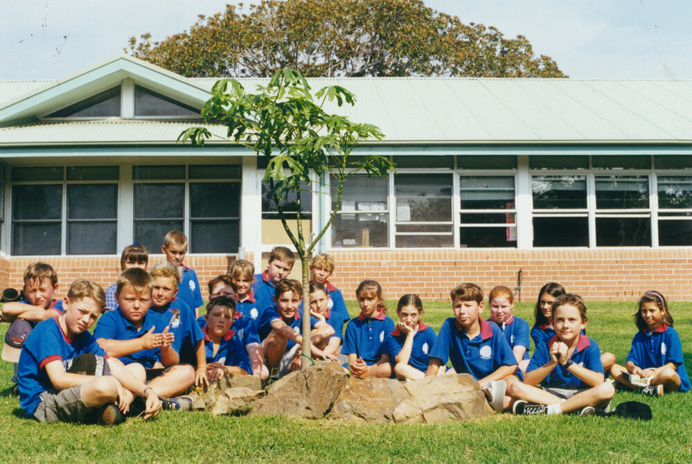 Shellharbour Public School class beside an Illawarra Flame Tree planted in 1996
