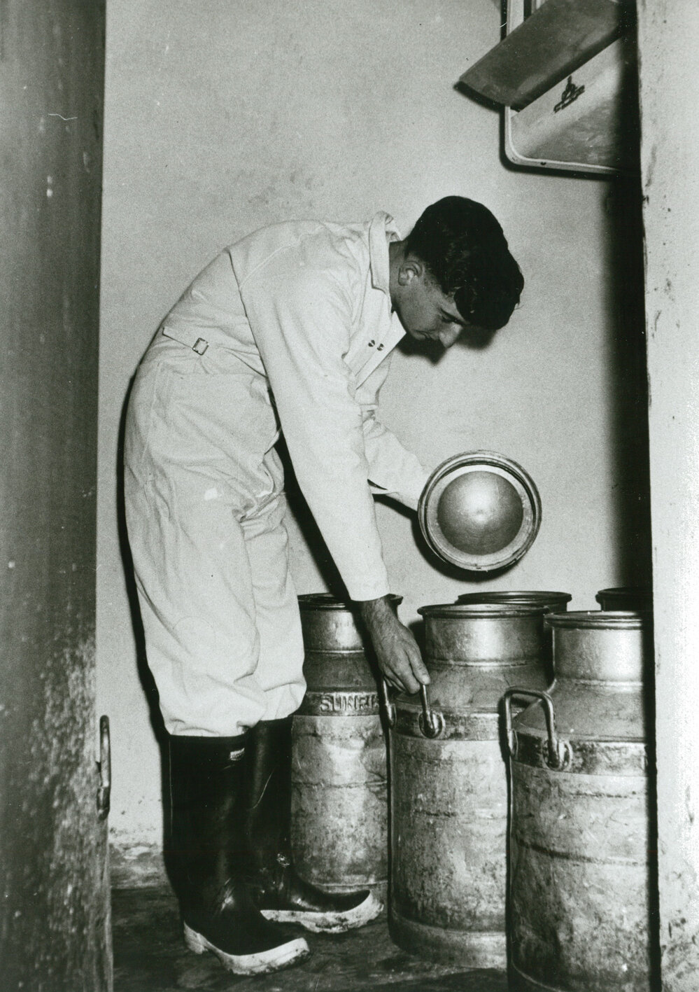 Ian Grey checking milk cans