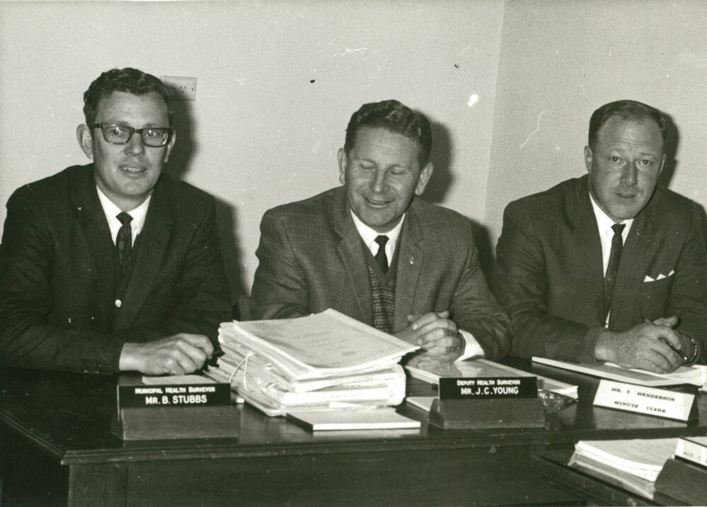 B Stubbs (Health surveyor), John Young (Health deputy) and T Henderson (Minute clerk) at Albion Park Council Chambers 1969