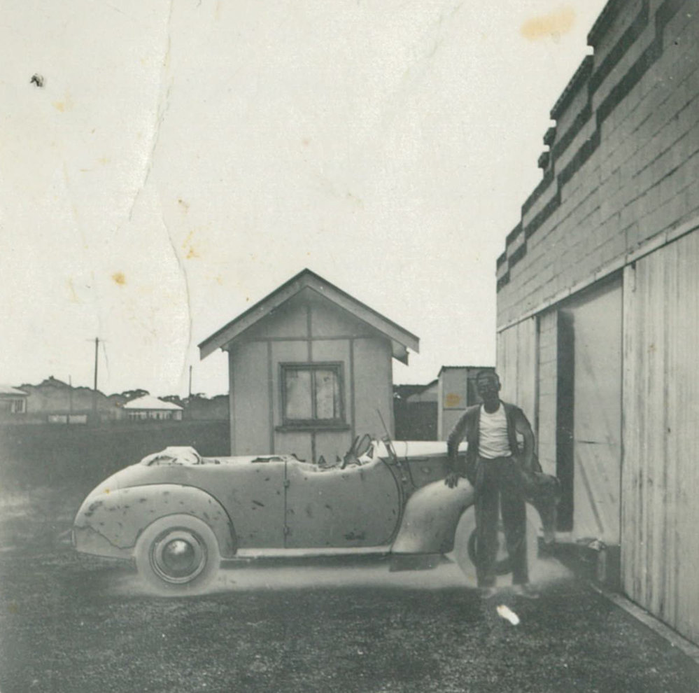 Dal Riddle in front of Cec Simpson's garage, Oak Flats