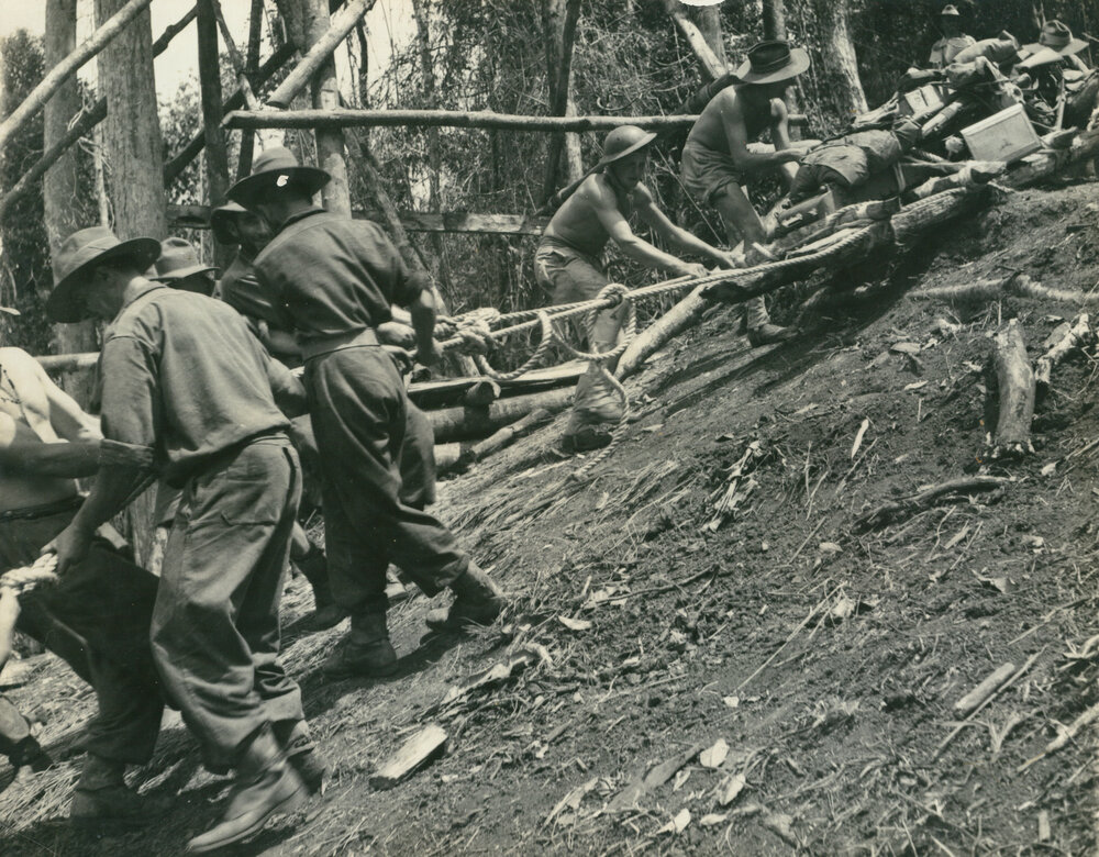 25 pounder being manhandled down from Owers Corner on the Kokoda Trail