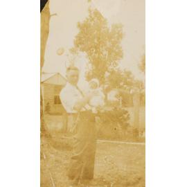 Alan Curr holding baby Carlene Pullen and Inskip's Dairy