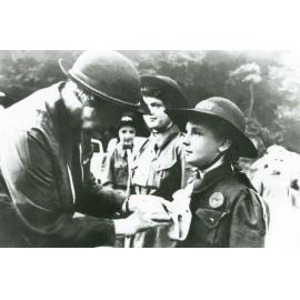 Rosemary Small receiving her Girl Guides badge from Lady Baden Powell at Mount Keira Scout Camp 1948