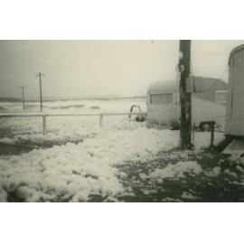 Foam from rough seas flowing through Bassett Park Camp Ground, Shellharbour