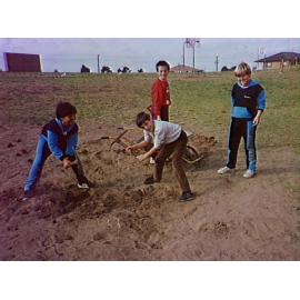 Pupils digging holes for trees at Barrack Heights Public School