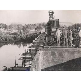 Installing water pipes across the Minnamurra River rail bridge