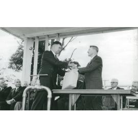 Mayor Keith Grey making a presentation to T H Upton, President MWB
